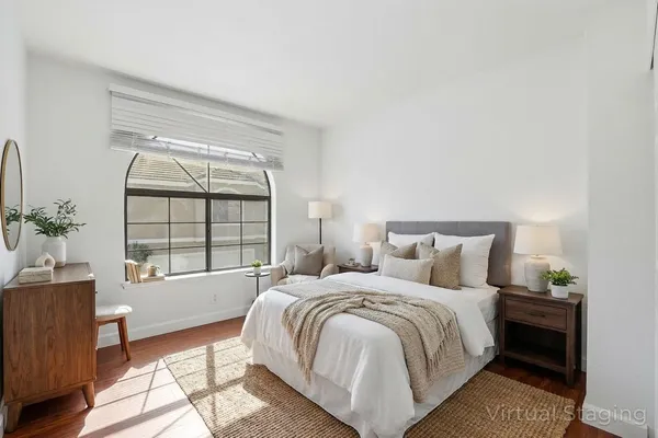 a bedroom with a bed and a window