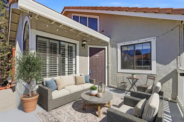 a view of a patio with couches and potted plants