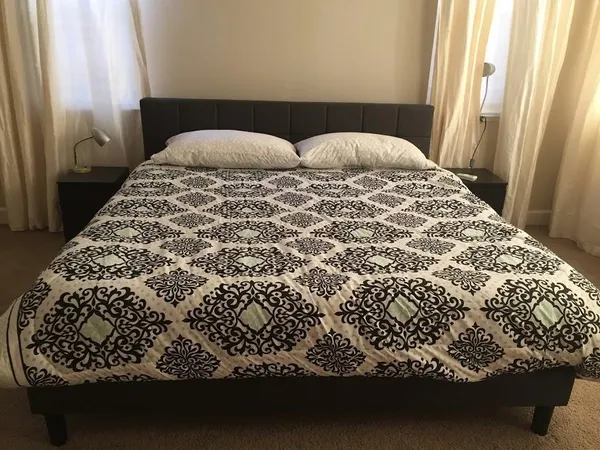 a bed sitting in a bedroom next to a window