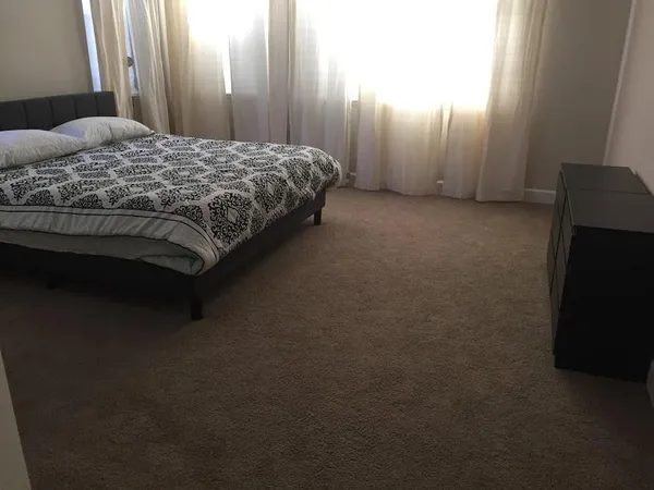 a bedroom with a bed and a closet