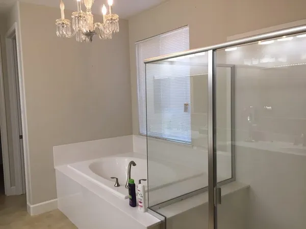 a bathroom with a bathtub and a shower