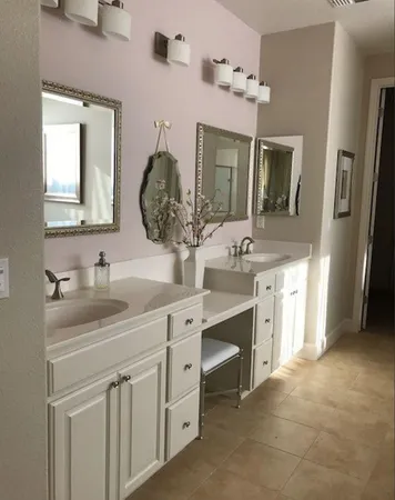 a spacious bathroom with a granite countertop sink a mirror and a shower