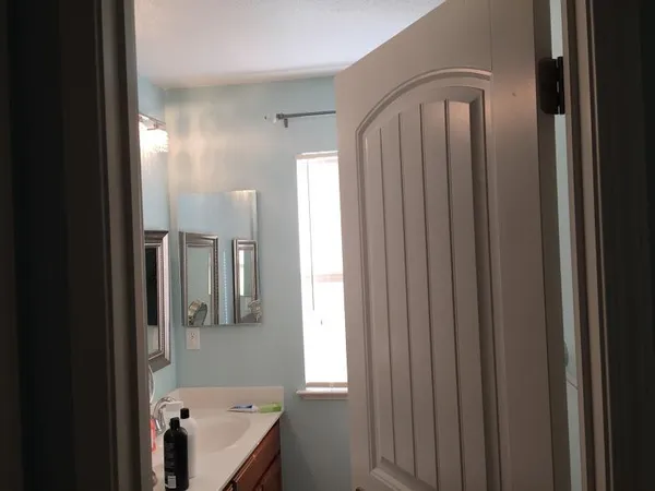 a bathroom with a tub shower and sink