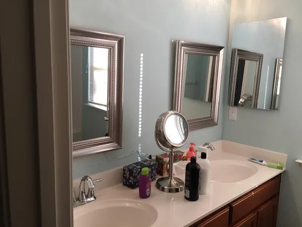 a bathroom with a sink double vanity and a mirror