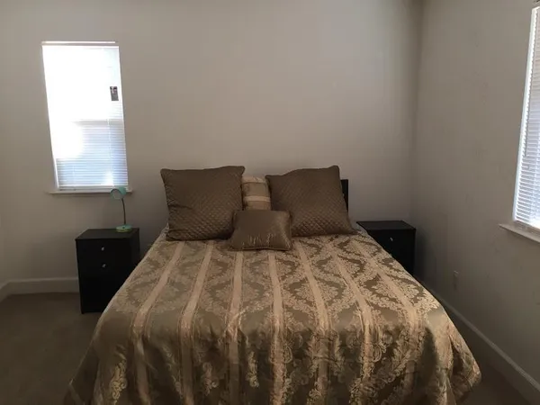 a bedroom with a bed and window