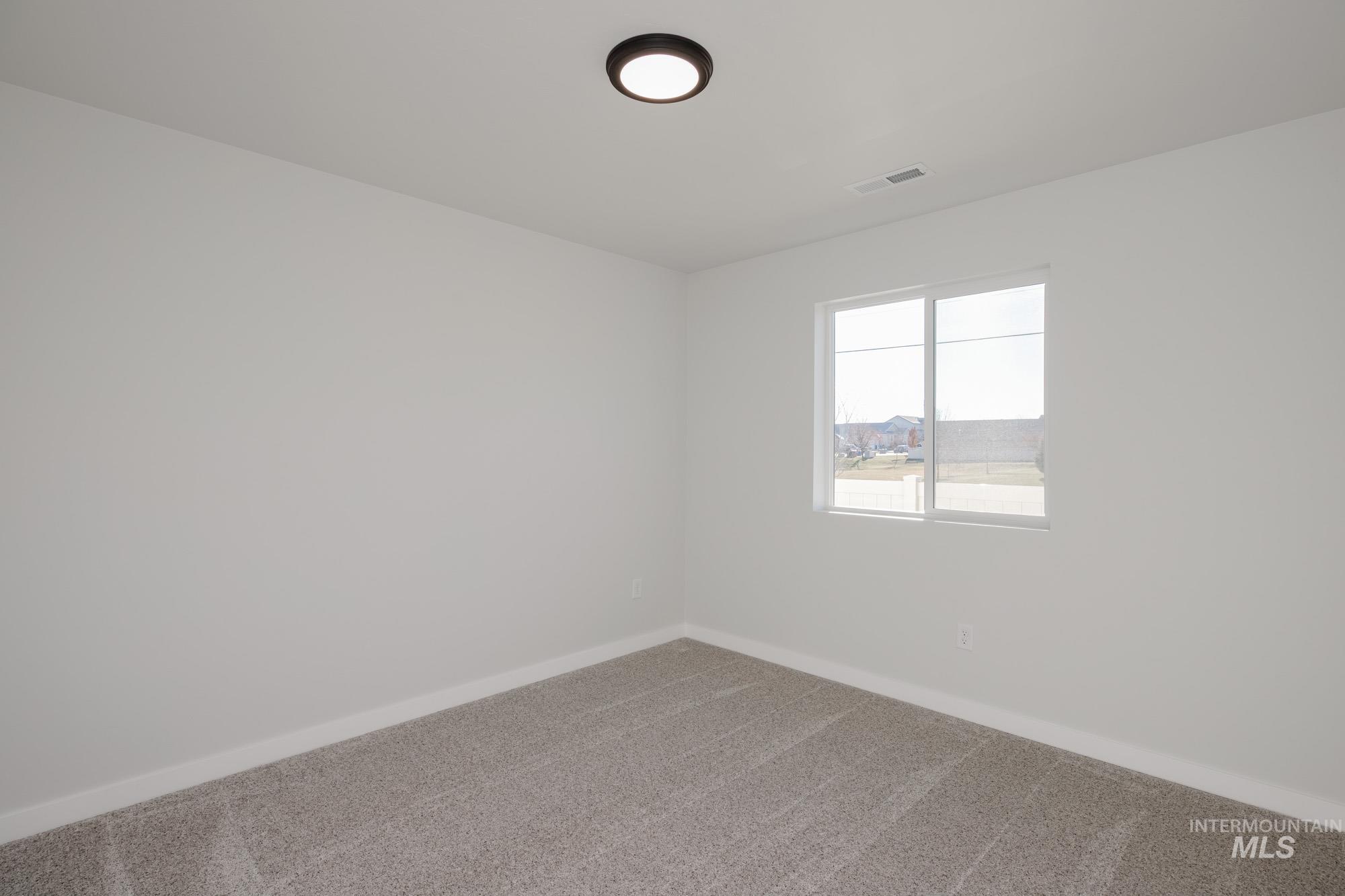 3310 South Maple Rnch Way Nampa, ID 83686 - Photo 10 of 19 Carpeted spare room with baseboards