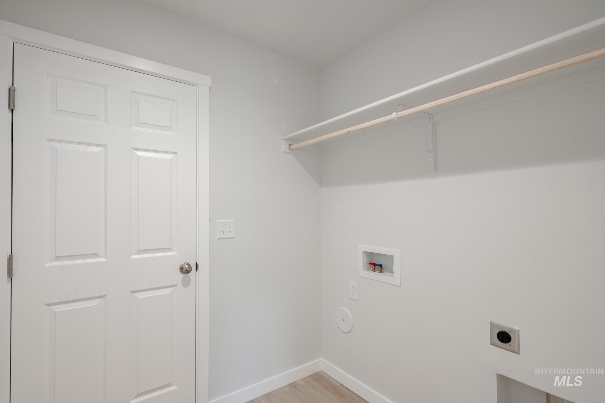 3310 South Maple Rnch Way Nampa, ID 83686 - Photo 12 of 19 Laundry area featuring hookup for a washing machine, electric dryer hookup, and light wood-style flooring