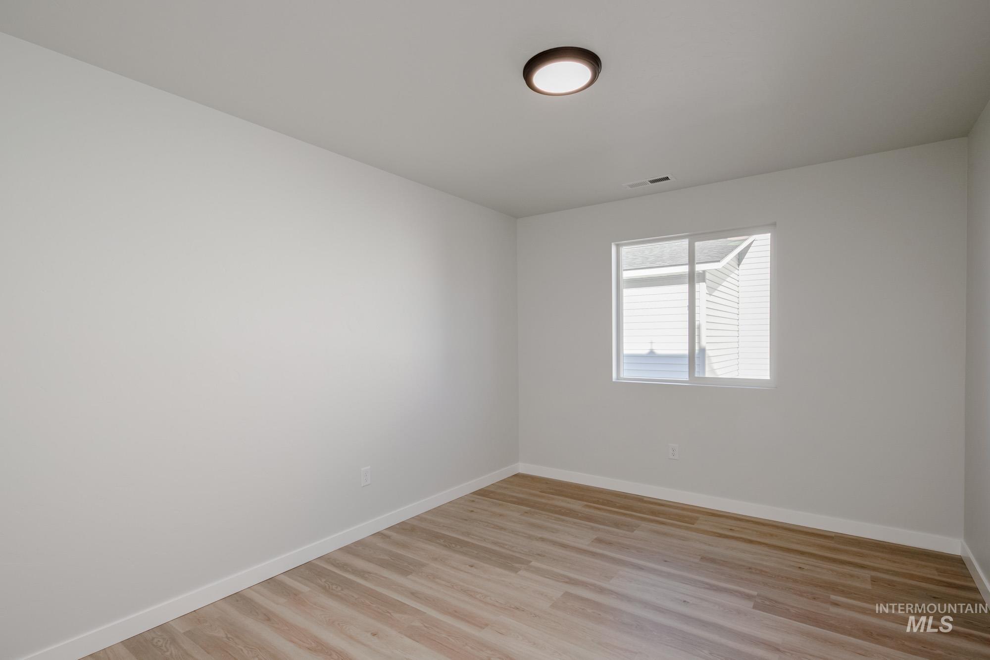 3310 South Maple Rnch Way Nampa, ID 83686 - Photo 13 of 19 Empty room with baseboards and light wood finished floors