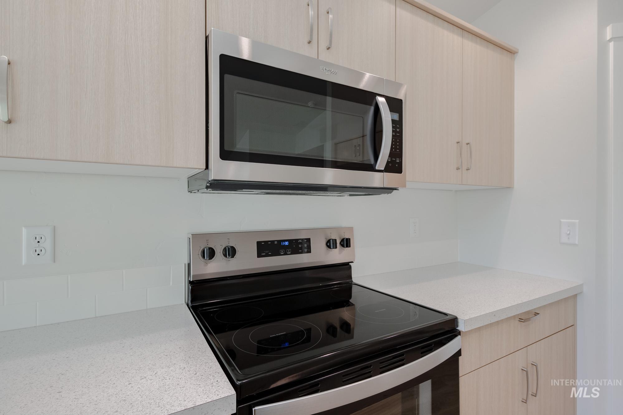 3310 South Maple Rnch Way Nampa, ID 83686 - Photo 4 of 19 Kitchen with light brown cabinets, appliances with stainless steel finishes, and modern cabinets