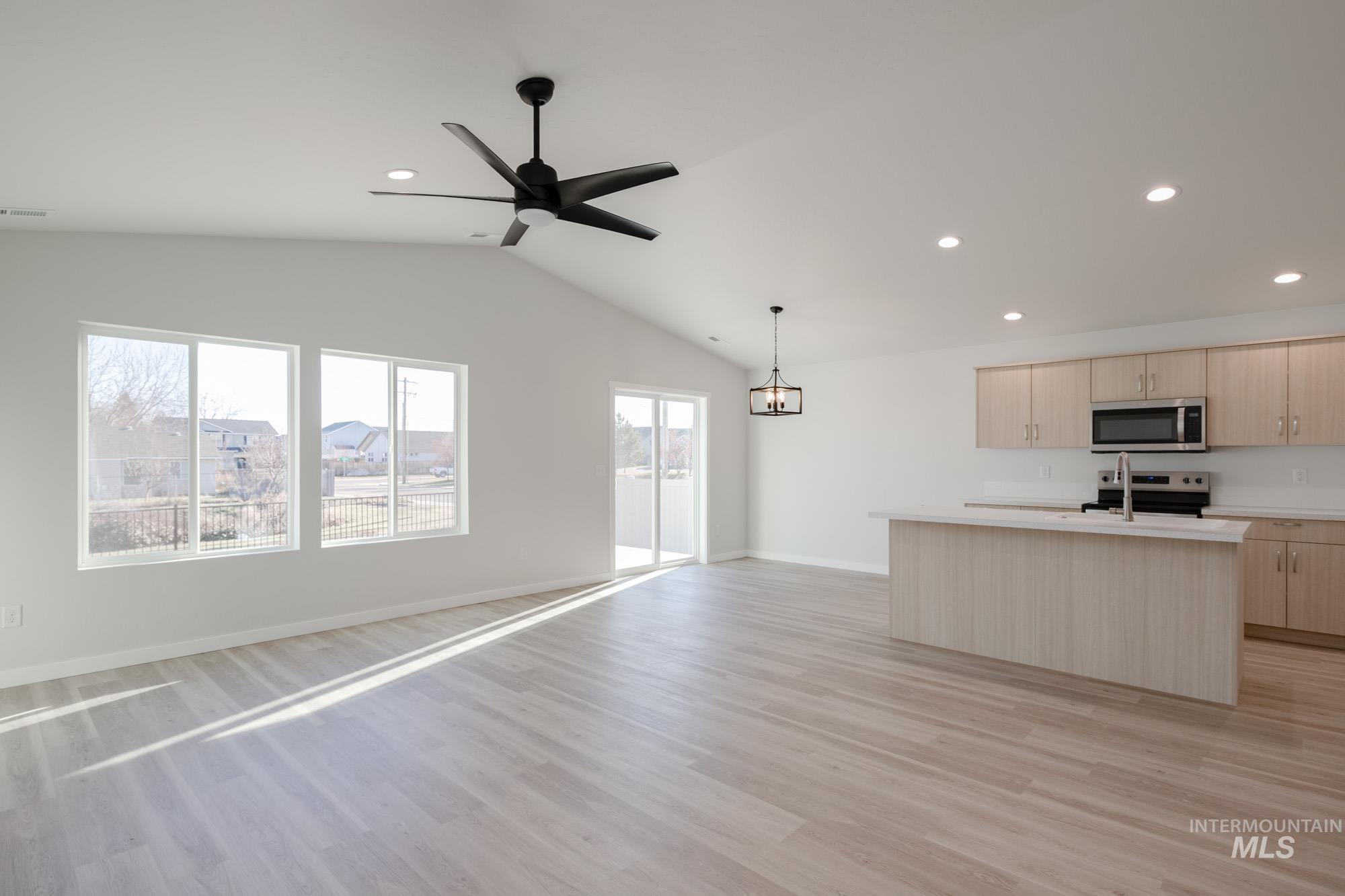 3310 South Maple Rnch Way Nampa, ID 83686 - Photo 19 of 19 Kitchen featuring open floor plan, an island with sink, light countertops, recessed lighting, and light brown cabinetry