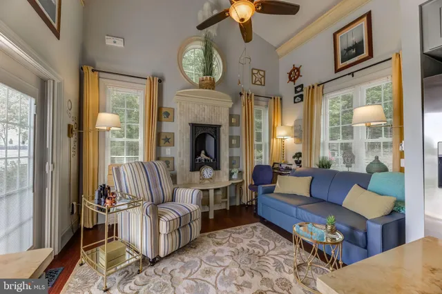 a living room with furniture fireplace and a large window