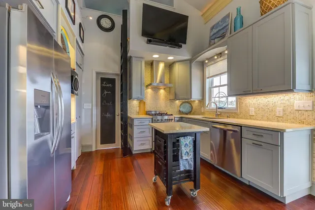a hall with cabinets a sink and a stove