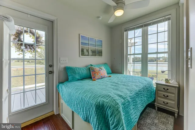 a bedroom with a bed and a large window