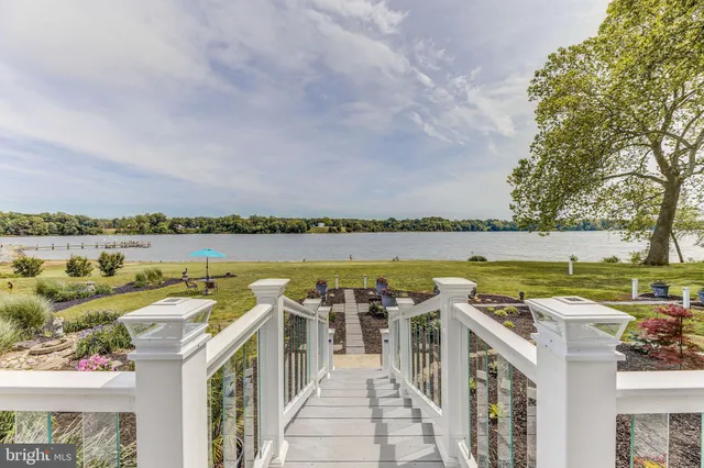 a view of a patio with furniture and a lake view