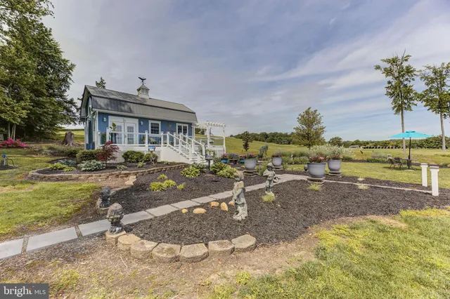 a view of a house with backyard and sitting area