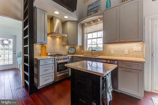 a kitchen with kitchen island granite countertop wooden cabinets and a stove