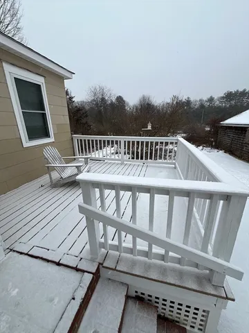 a roof deck with a wooden fence and floor
