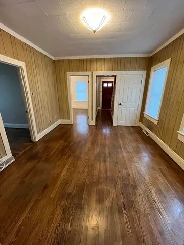 wooden floor in an empty room with a window