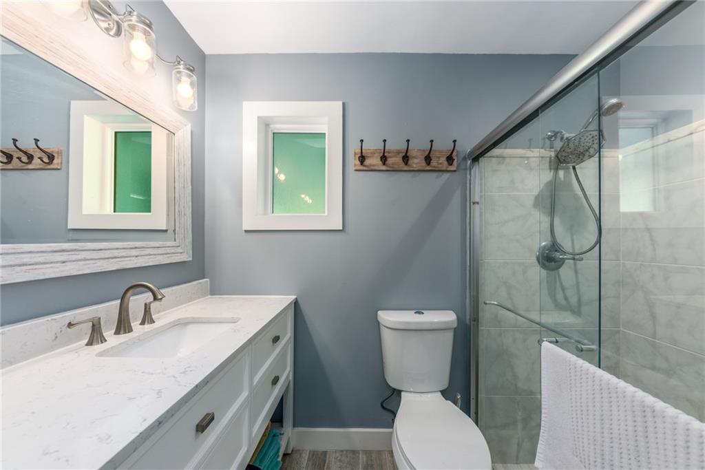 1453 Northwest Spruce Ridge Drive Stuart, FL 34994 - Photo 17 of 27 a bathroom with a sink a toilet and shower