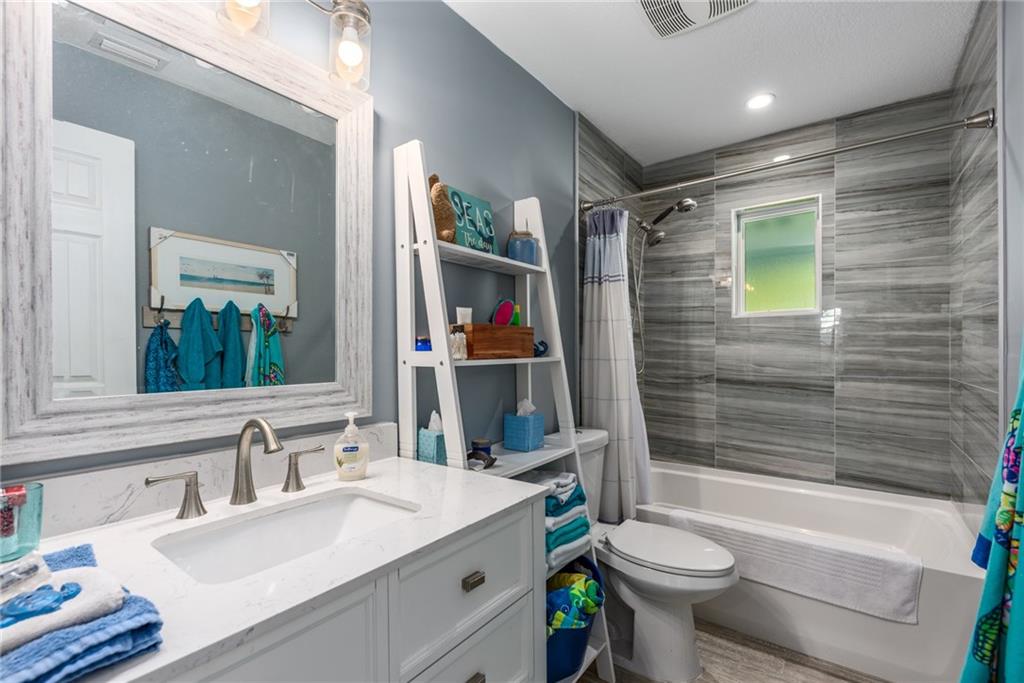 1453 Northwest Spruce Ridge Drive Stuart, FL 34994 - Photo 20 of 27 a bathroom with a sink toilet and shower
