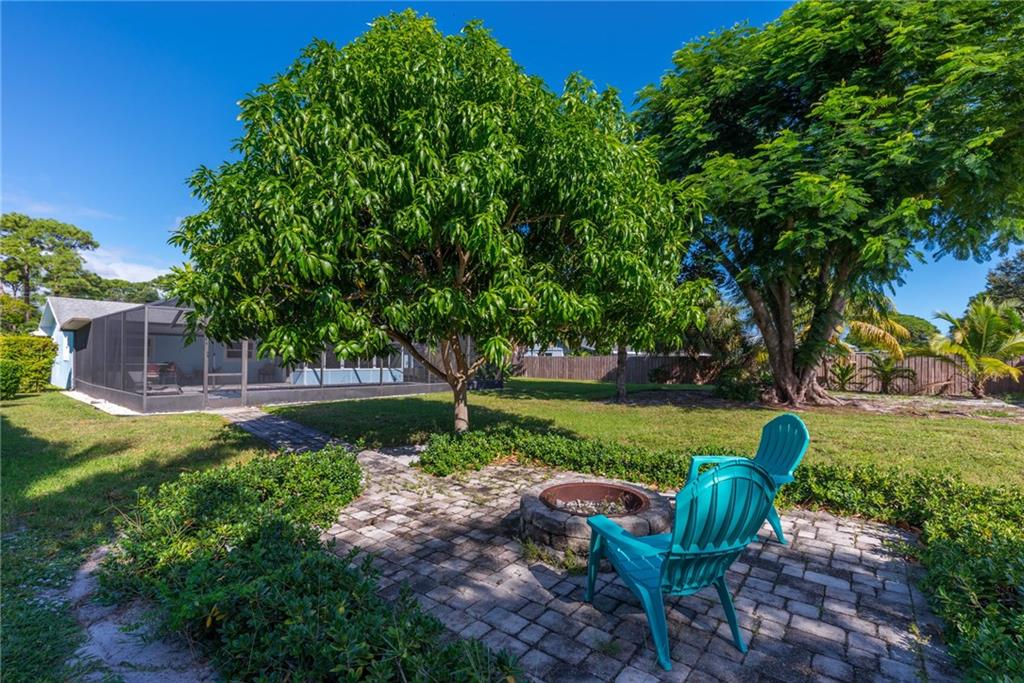 1453 Northwest Spruce Ridge Drive Stuart, FL 34994 - Photo 22 of 27 a view of a garden with plants and trees
