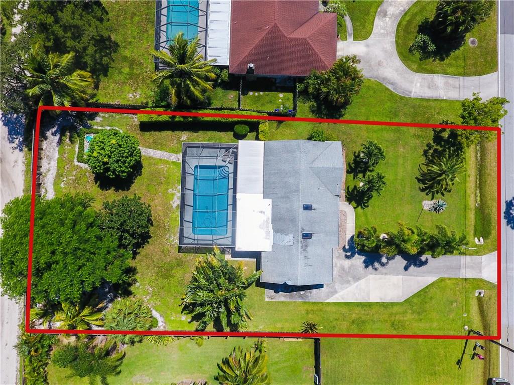 1453 Northwest Spruce Ridge Drive Stuart, FL 34994 - Photo 27 of 27 an aerial view of a house with a yard