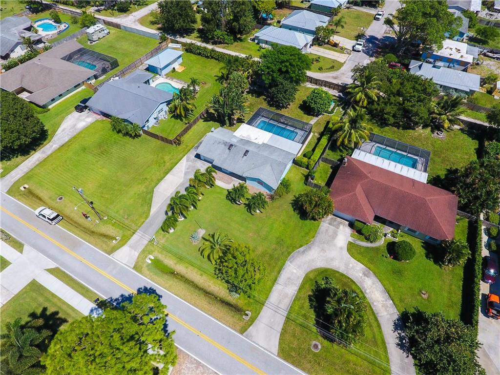 1453 Northwest Spruce Ridge Drive Stuart, FL 34994 - Photo 5 of 27 an aerial view of a house with a garden and swimming pool
