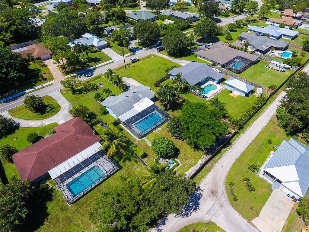 1453 Northwest Spruce Ridge Drive Stuart, FL 34994 - Photo 6 of 27 an aerial view of residential houses with outdoor space and swimming pool