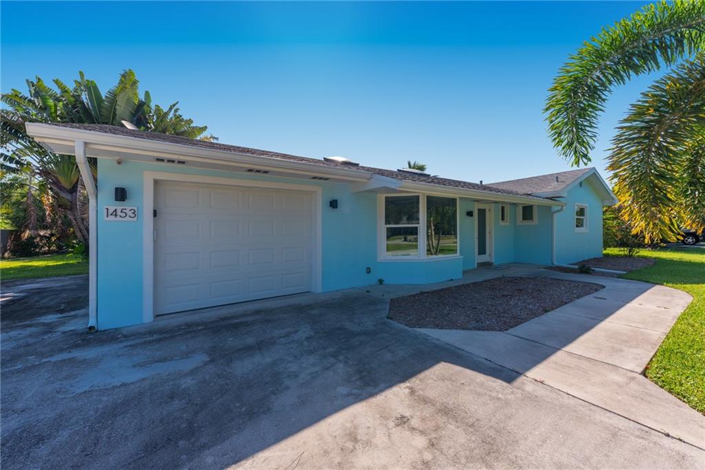 1453 Northwest Spruce Ridge Drive Stuart, FL 34994 - Photo 8 of 27 a view of a house with a yard