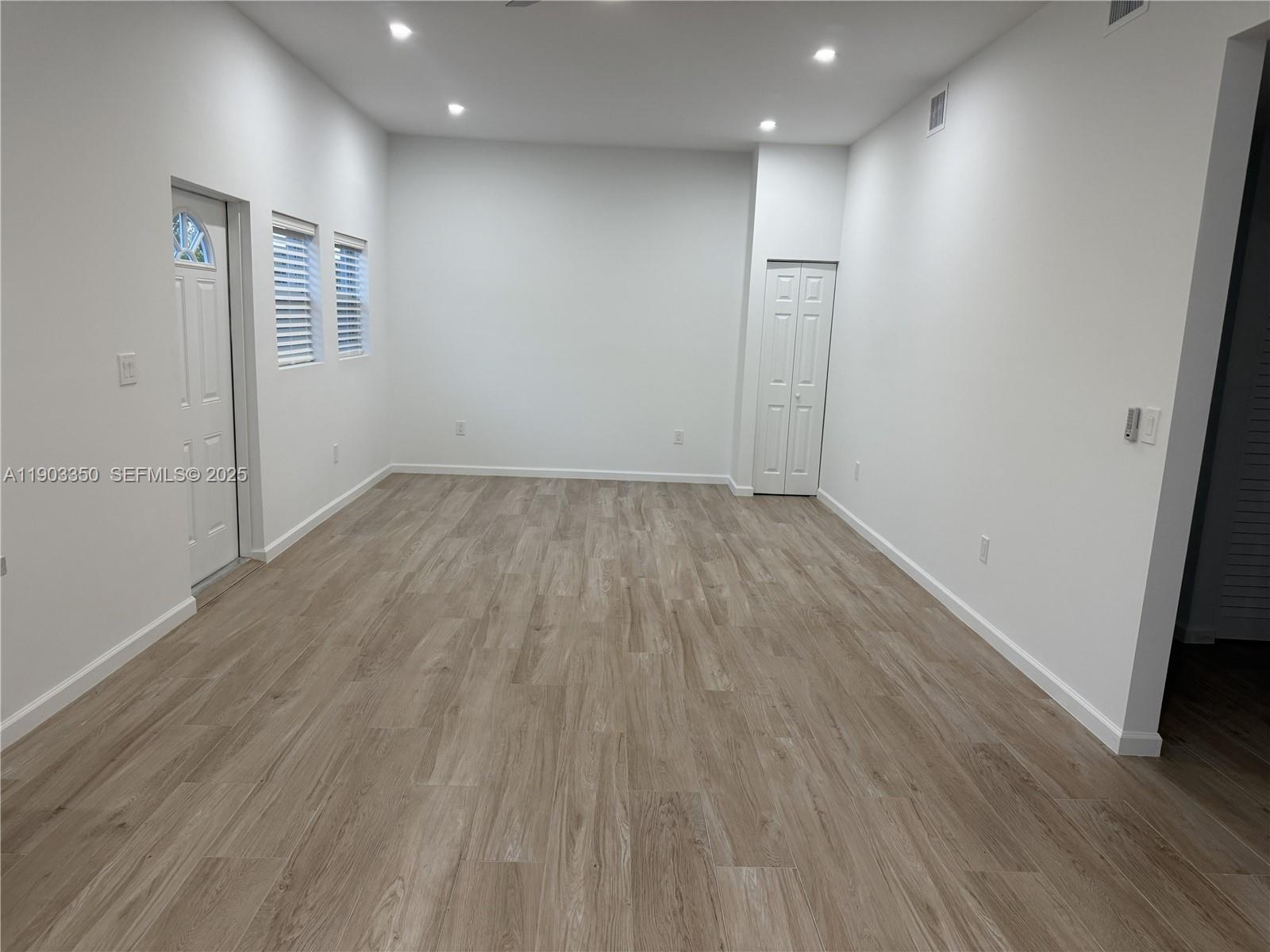 Southwest Ranches Southwest Ranches, FL 33331 - Photo 7 of 15 an empty room with wooden floor and windows