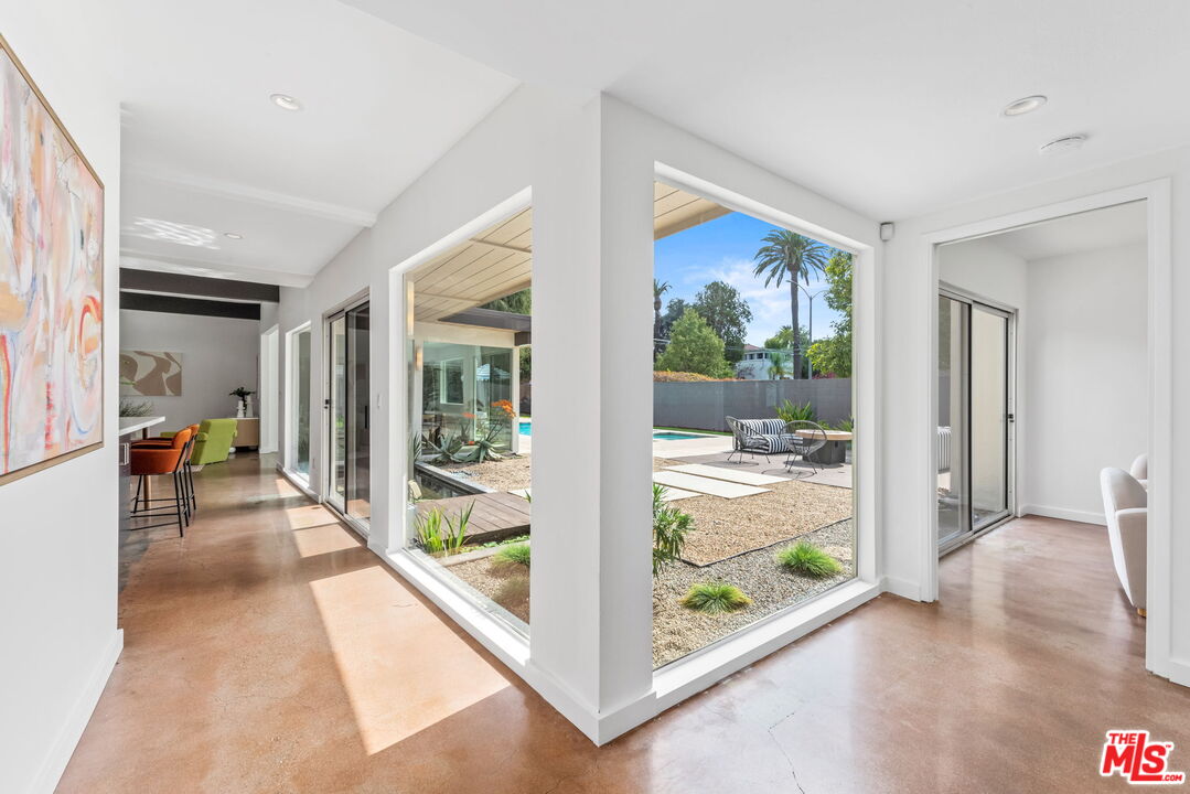 1680 Virginia Road Los Angeles, CA 90019 - Photo 4 of 51 a view of a hallway with wooden floor and windows