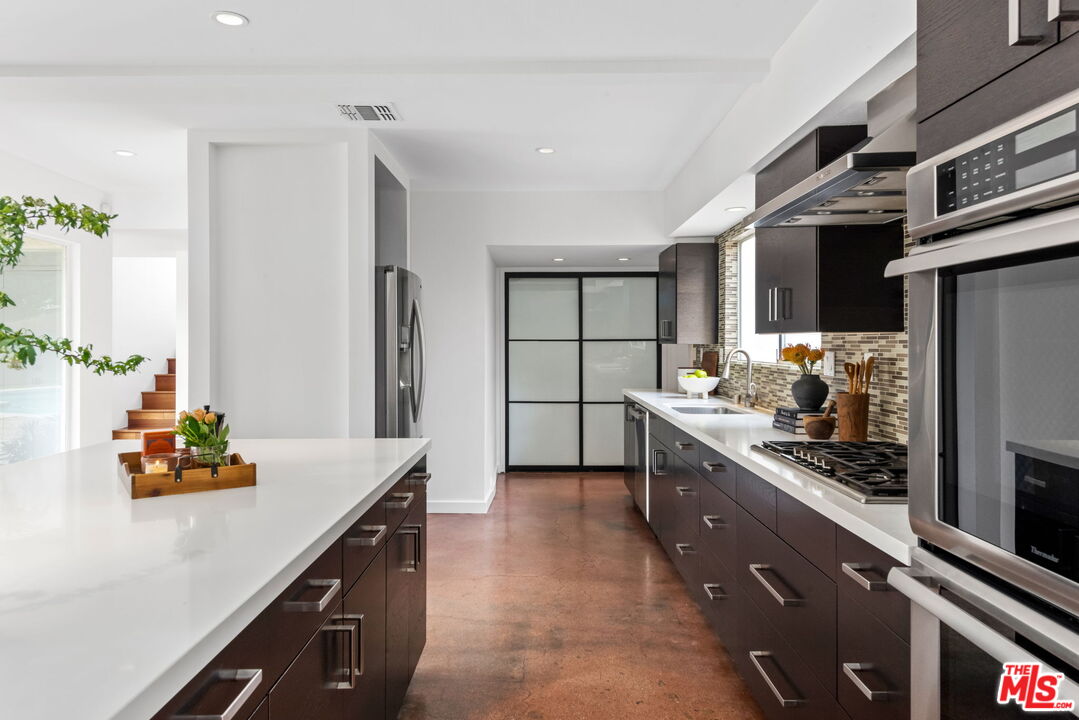 1680 Virginia Road Los Angeles, CA 90019 - Photo 8 of 51 a kitchen with stainless steel appliances a sink stove and refrigerator