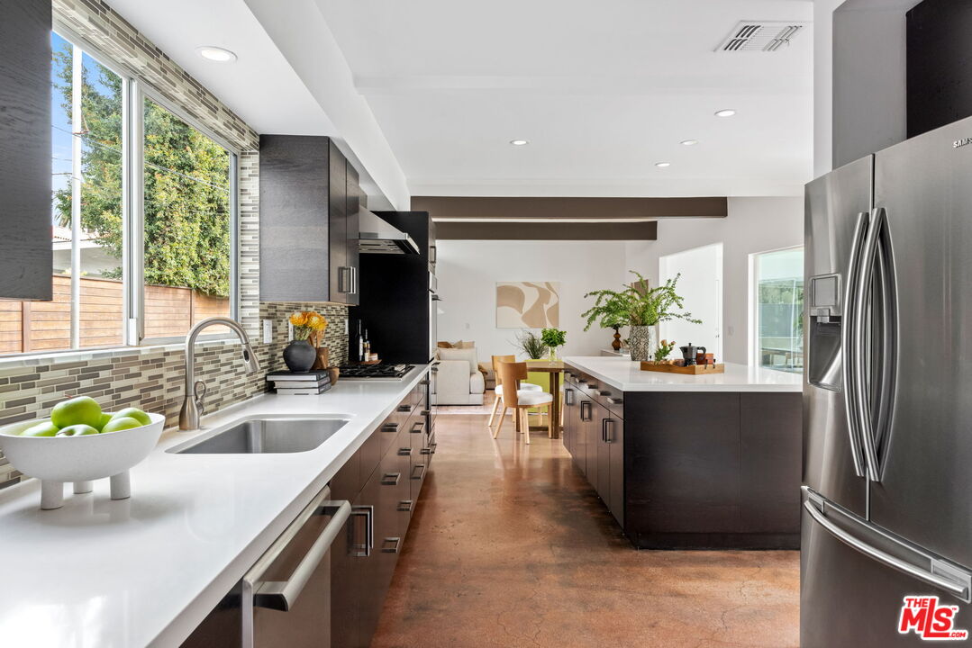 1680 Virginia Road Los Angeles, CA 90019 - Photo 9 of 51 a kitchen with stainless steel appliances granite countertop a sink a stove and a refrigerator