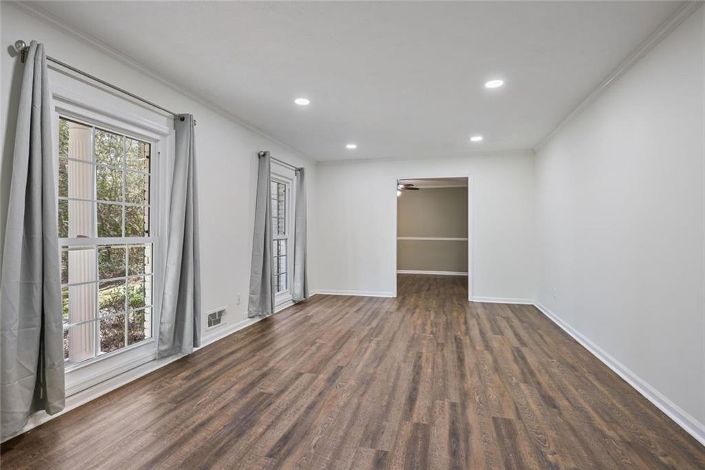 4505 Cochran Mill Road Fairburn, GA 30213 - Photo 5 of 36 a view of an empty room with wooden floor and a window