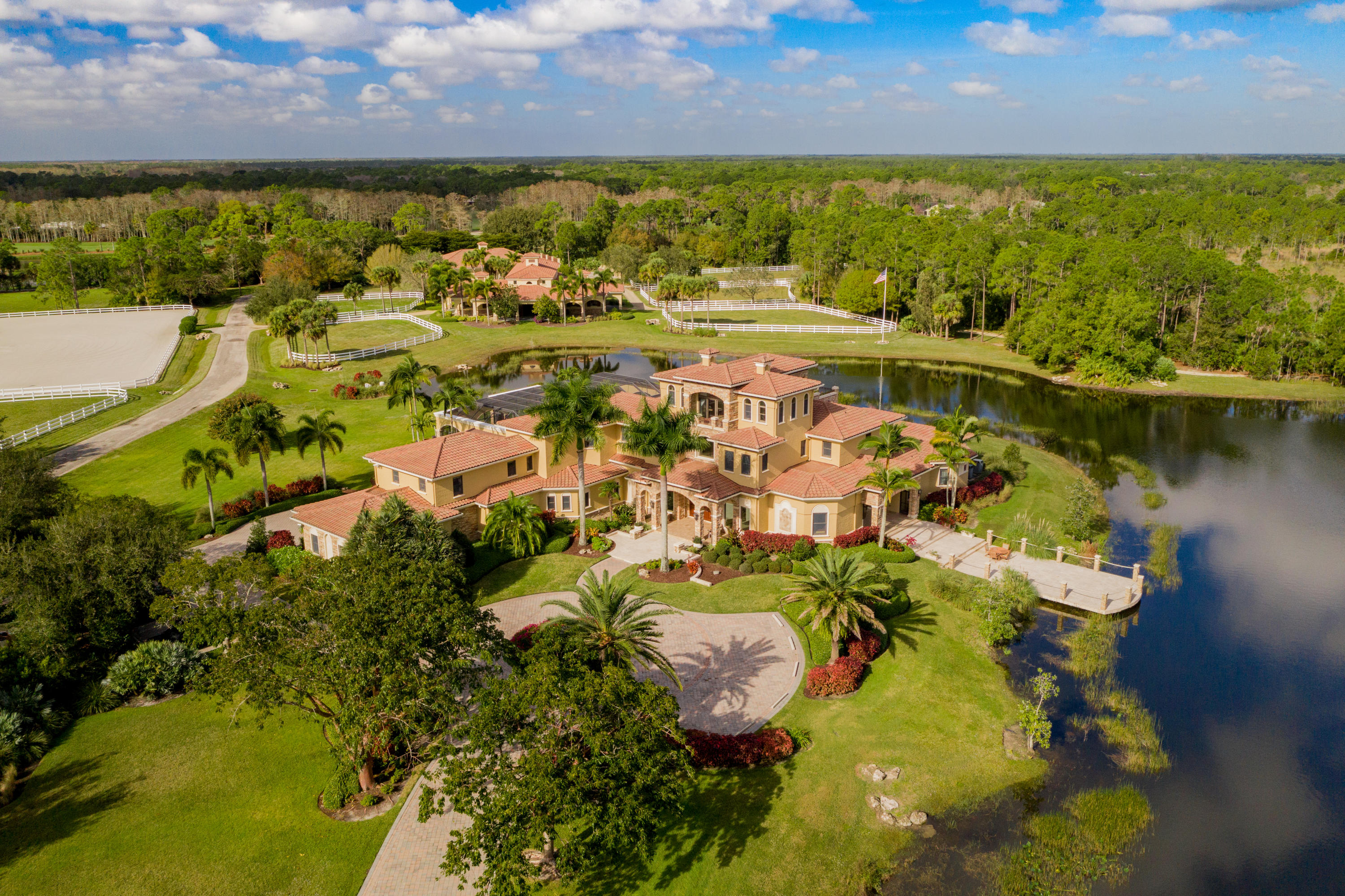 19700 Mack Dairy Road Jupiter, FL 33478 - Photo 1 of 48 a view of a lake with lawn chairs