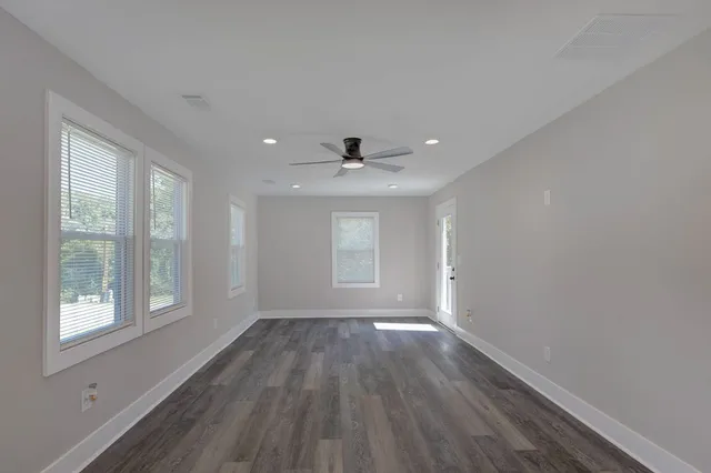 wooden floor in an empty room with a window