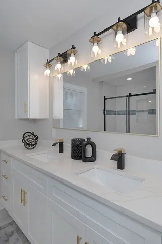 a bathroom with a glass shower door