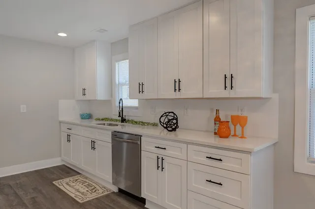 a kitchen with stainless steel appliances a refrigerator sink and microwave