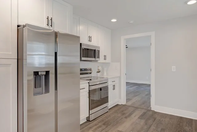 a kitchen with stainless steel appliances a stove microwave and a refrigerator