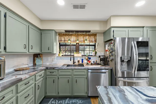 a kitchen with a sink stove and refrigerator