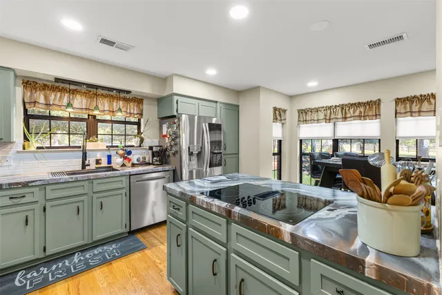 a kitchen that has a sink and cabinets