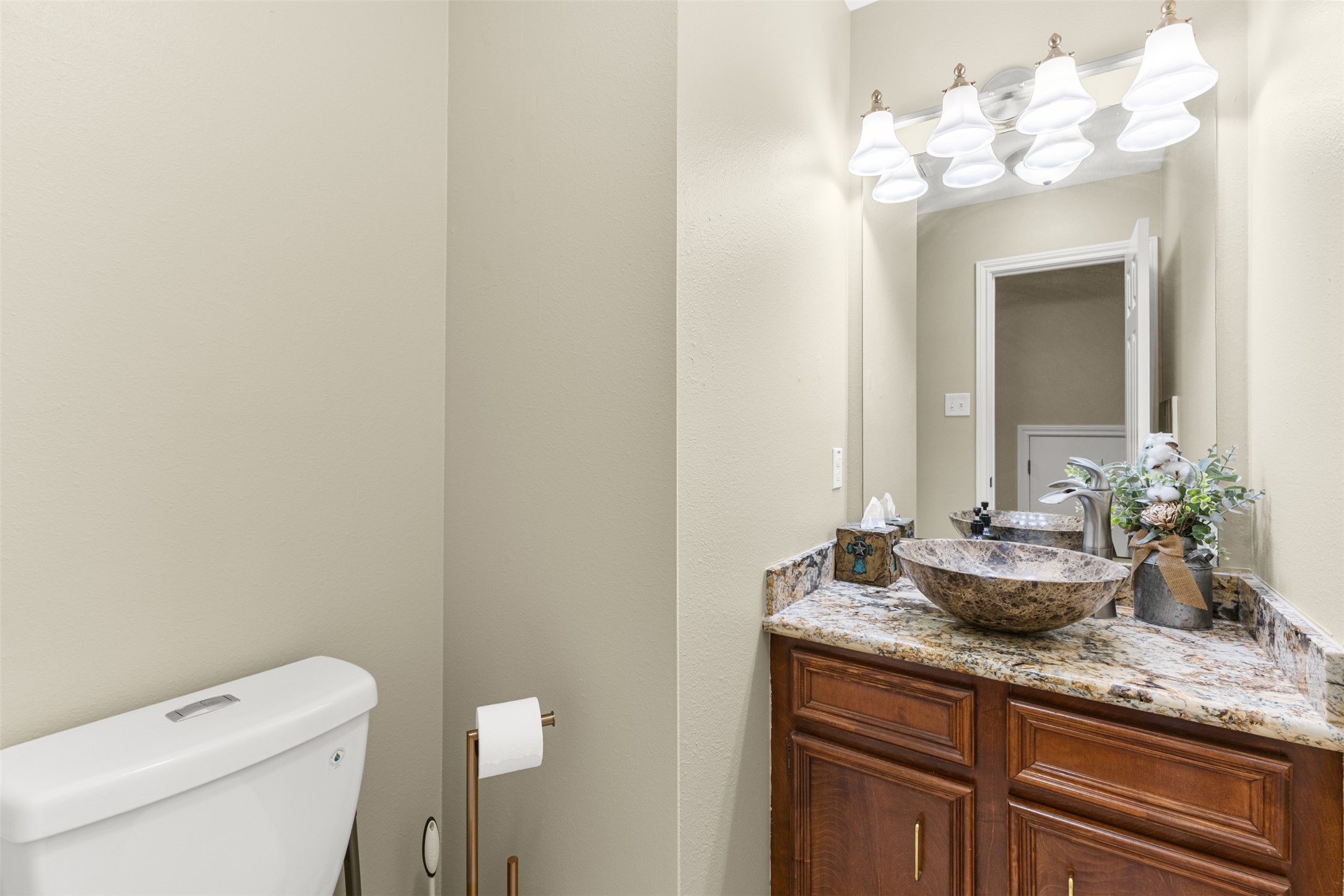 31928 Reids Prairie Road Waller, TX 77484 - Photo 17 of 49 a bathroom with a granite countertop sink a toilet and a mirror