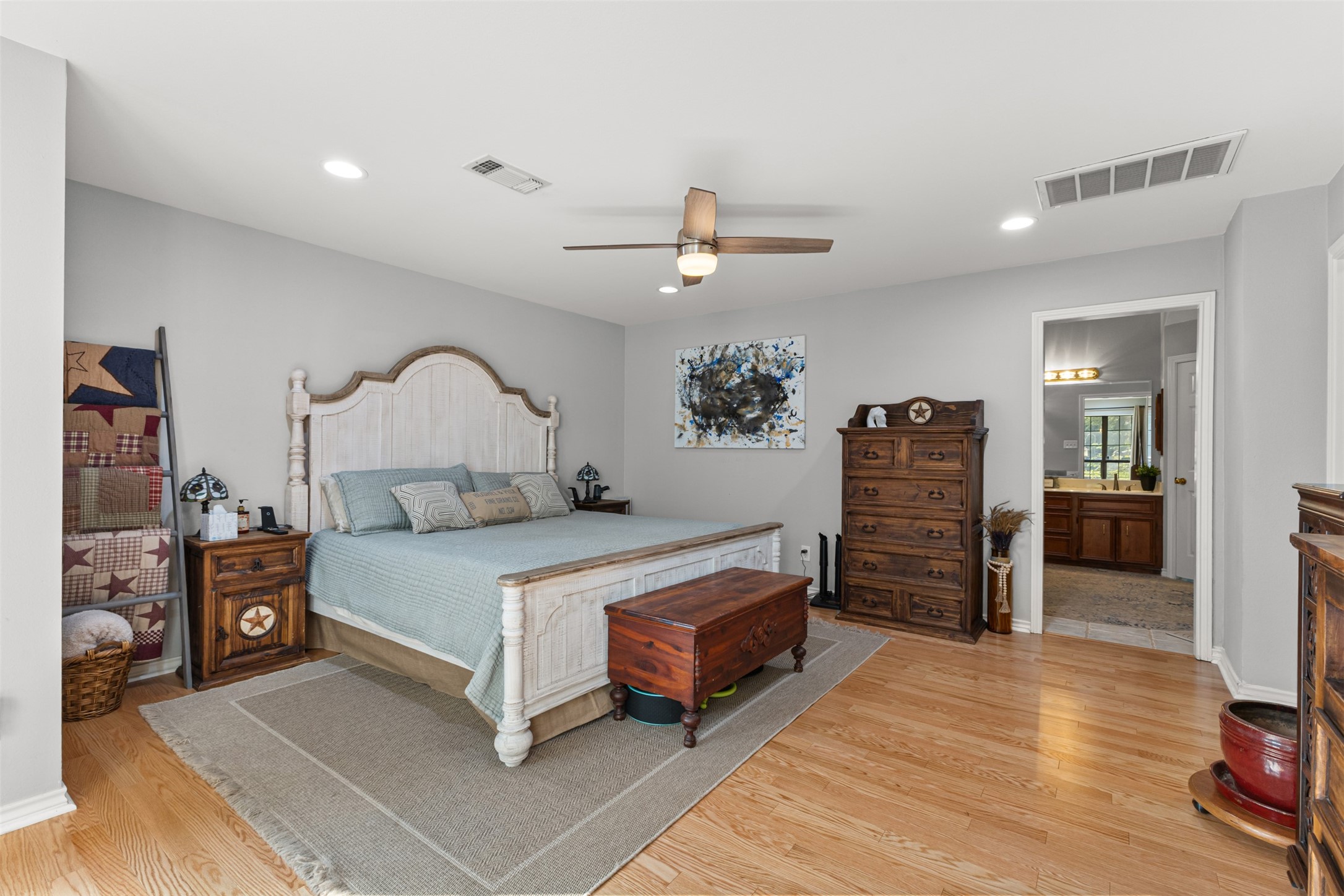 31928 Reids Prairie Road Waller, TX 77484 - Photo 24 of 49 a bedroom with a bed and a chandelier