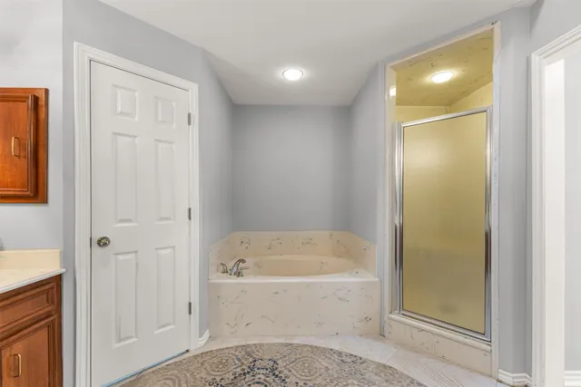 a bathroom with a bathtub and shower