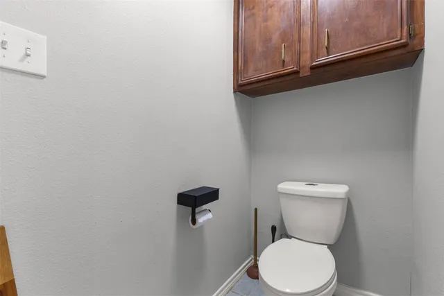 a white toilet sitting next to a sink