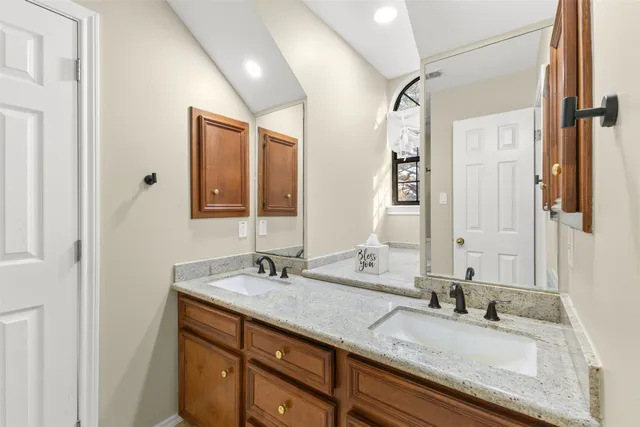 a bathroom with a granite countertop sink mirror and double