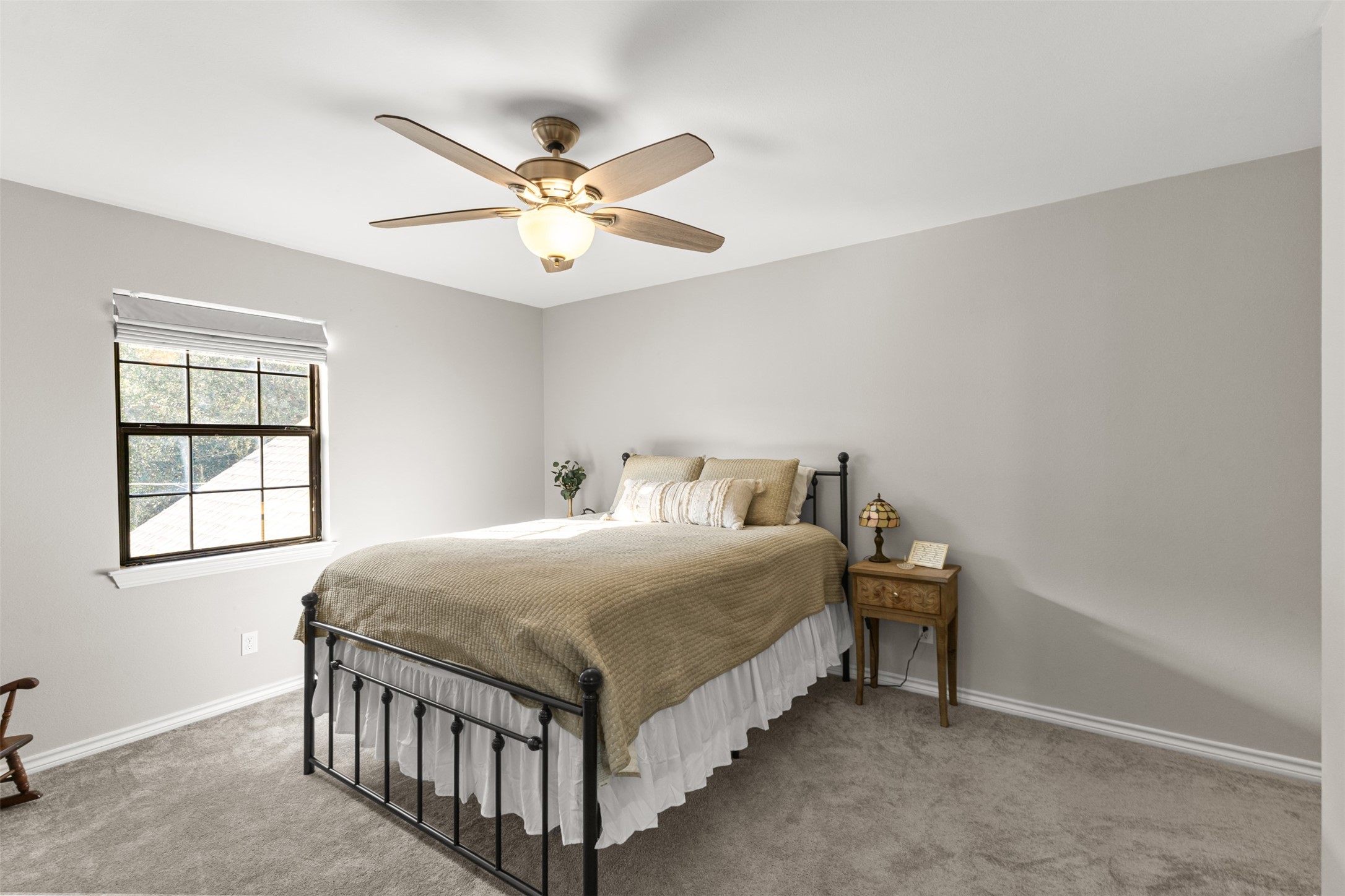 31928 Reids Prairie Road Waller, TX 77484 - Photo 31 of 49 a bedroom with a bed and a chandelier