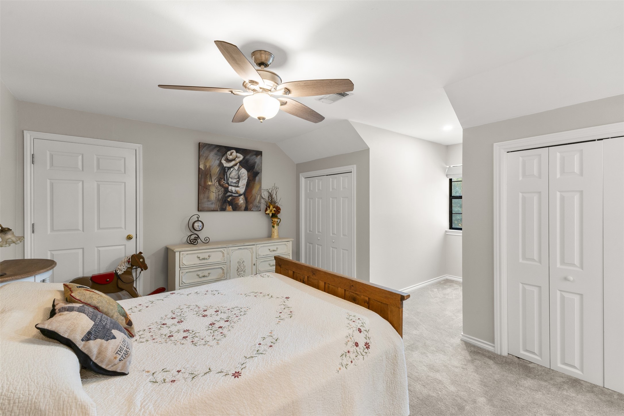 31928 Reids Prairie Road Waller, TX 77484 - Photo 33 of 49 a bedroom with a bed and a chandelier