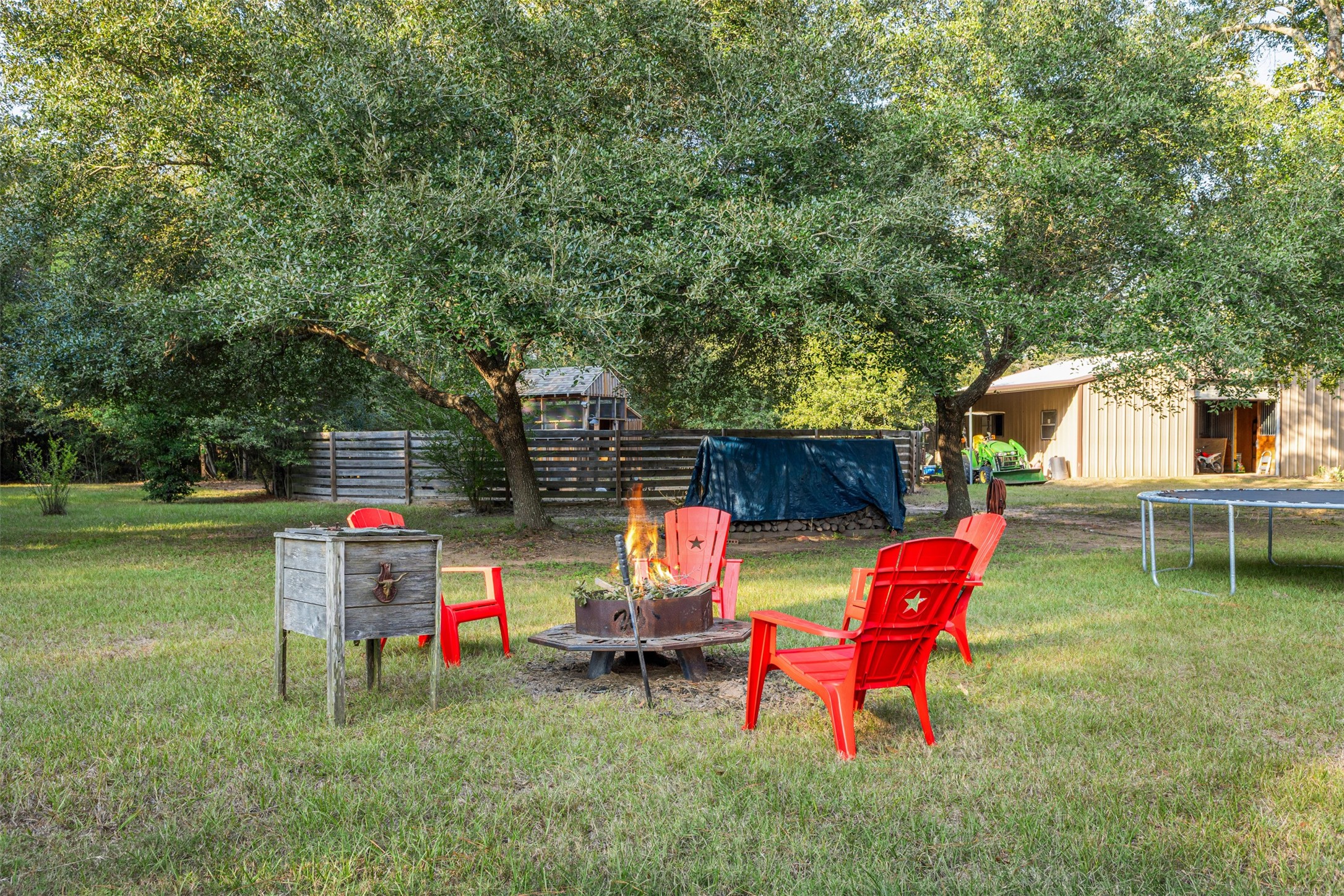 31928 Reids Prairie Road Waller, TX 77484 - Photo 40 of 49 a backyard of a house with fire pit and outdoor seating