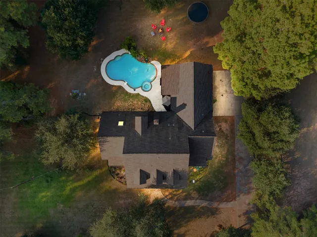 an aerial view of a house with pool yard and outdoor seating